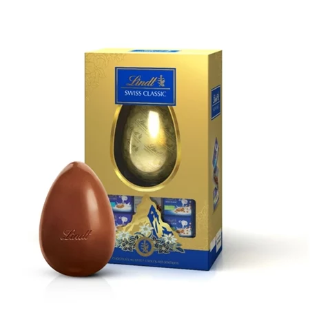 Ovo de Páscoa Lindt Swiss Classic de 130g ao lado de sua caixa dourada com detalhes em azul e logo da marca