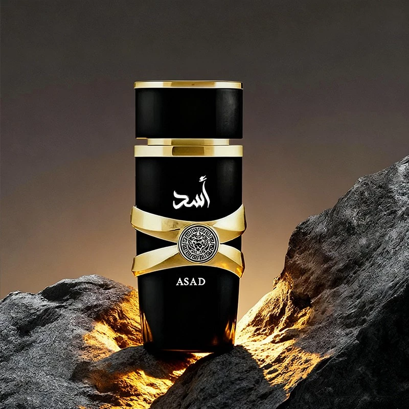 Frasco do perfume Lattafa Asad posicionado entre rochas escuras com iluminação dourada dramática ao fundo